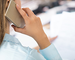 Woman with a mobile phone and documents